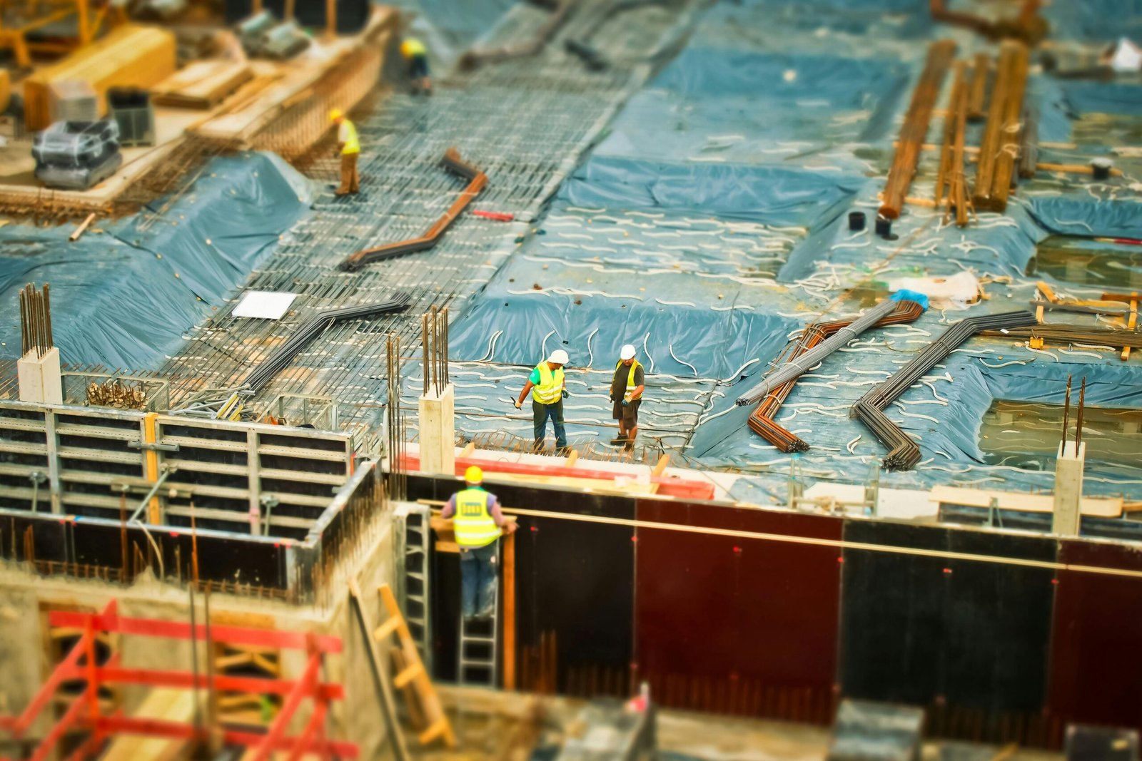 construction site with workers working on putting concrete foundation